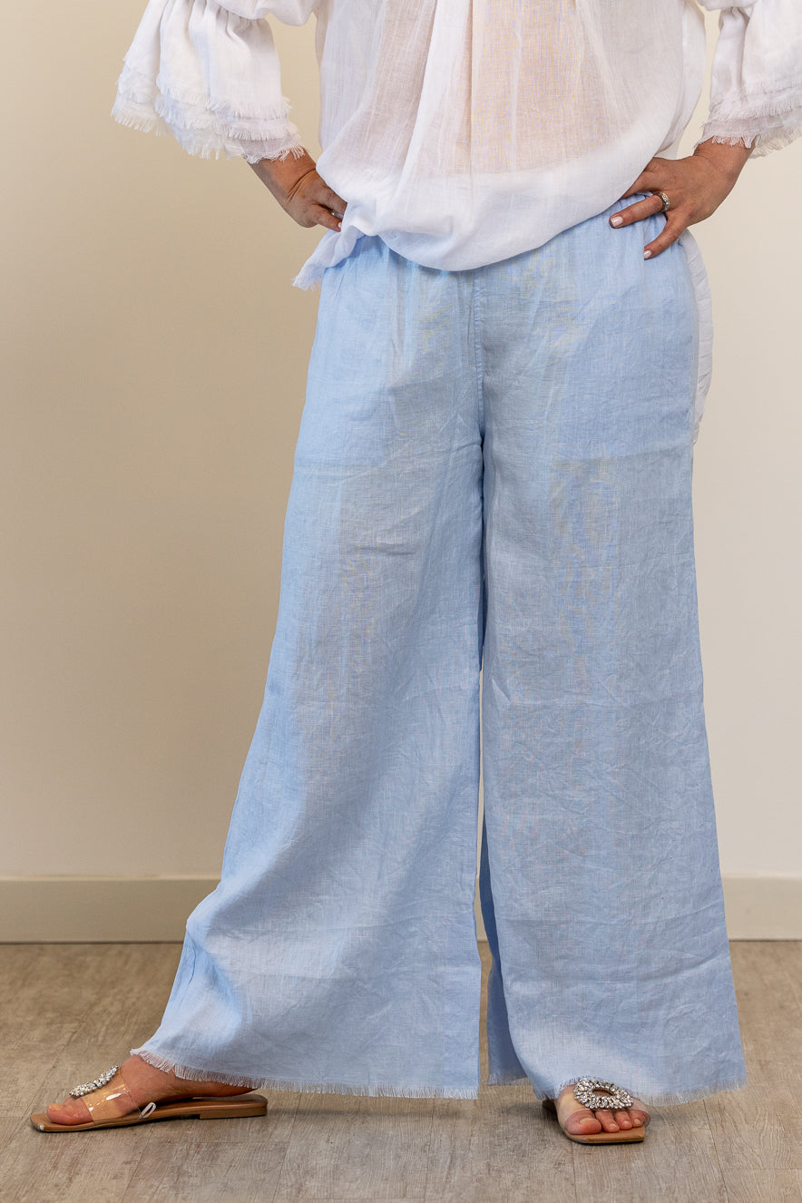 Wide legged frayed hem pants in pale blue linen by The Tailor & his Lover
